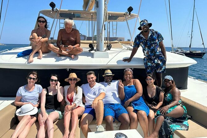 Luxury Santorini Catamaran Cruise: Lunch, BBQ, Drinks, Transfers - The onboard vibe: comfort, friendliness, and who keeps the day rolling