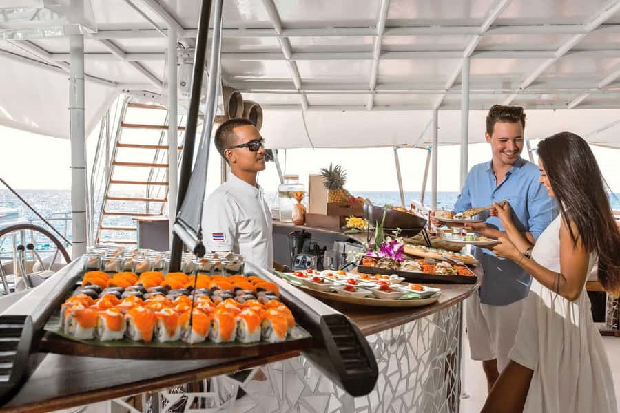 Phuket: Coral and Racha Islands Hype Luxury Catamaran - The onboard party shift: DJ, sunset, and dancing on the return