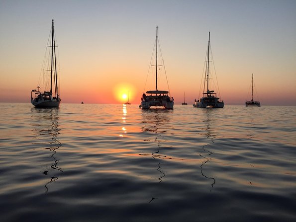Santorini Luxury Catamaran Sunset Cruise with BBQ, Drink and Transfer - Sunset timing: when the day shifts to golden hour