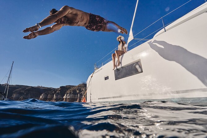 Santorini Oia: Luxury Sunset Cruise with Fresh Fish BBQ & Drinks - The volcano and sulfur springs: floating in salt-rich water