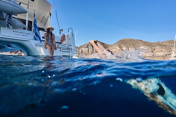 Santorini Oia: Luxury Sunset Cruise with Fresh Fish BBQ & Drinks - Nea Kameni’s lava rocks: volcanic color and easy buoyancy