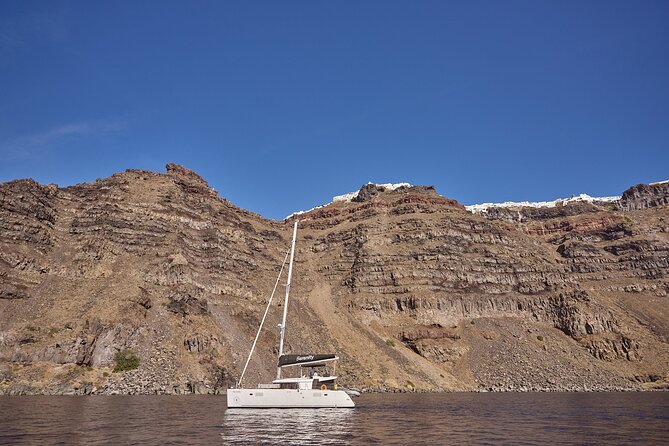 Santorini Oia: Luxury Sunset Cruise with Fresh Fish BBQ & Drinks - Mesa Pigadia and the boat-only beaches: black sand, clear water, big photos
