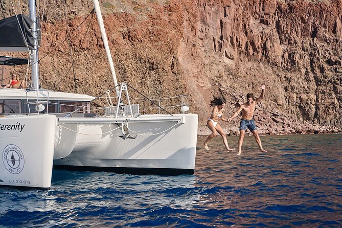 Santorini Oia: Luxury Sunset Cruise with Fresh Fish BBQ & Drinks - Red Beach hour: turquoise water plus volcanic drama and onboard BBQ