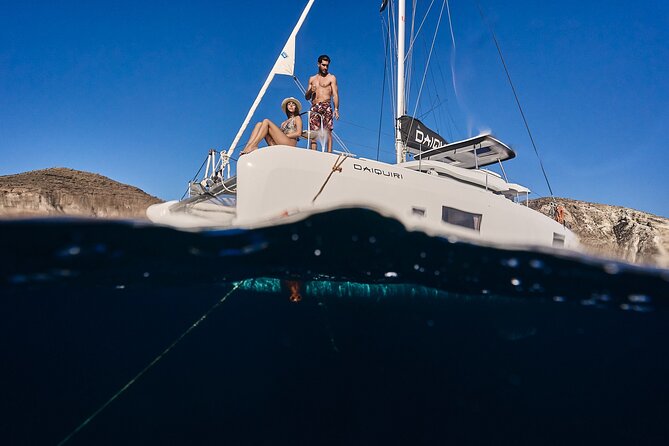 Santorini Oia: Luxury Sunset Cruise with Fresh Fish BBQ & Drinks - Sunset off the sea: watching from the oldest ports area