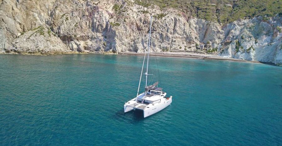 Santorini: Southern Island Luxury Catamaran Cruise with Meal - Akrotiri Lighthouse passing by: a quick history beat with the right tempo